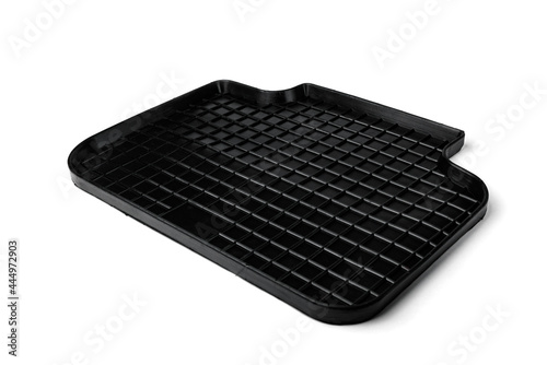 Black rubber car mat isolated on white background.