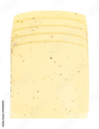Truffle cheese slices. Stack of sliced cheddar for cheeseburgers, made of pasteurized cow milk, and truffle flakes. Dairy product. Light yellow. Close-up, from above, isolated, over white, food photo.