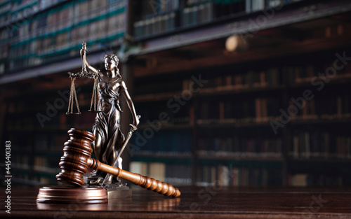 Law theme. Themis statue and judge gavel in the law faculty library.