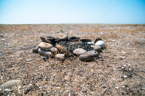 The extinguished campfire and the beach.