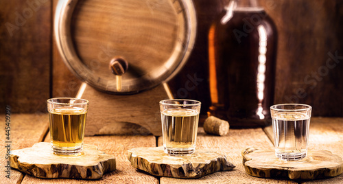 typical brazilian brandy glass, called "pinga" or "cachaça", made of sugar cane, rustic still setting