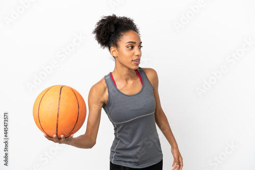Young basketball player latin woman isolated on white background playing basketball