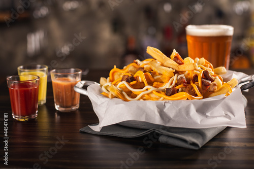 portion of french fries with cheddar and bacon bar food