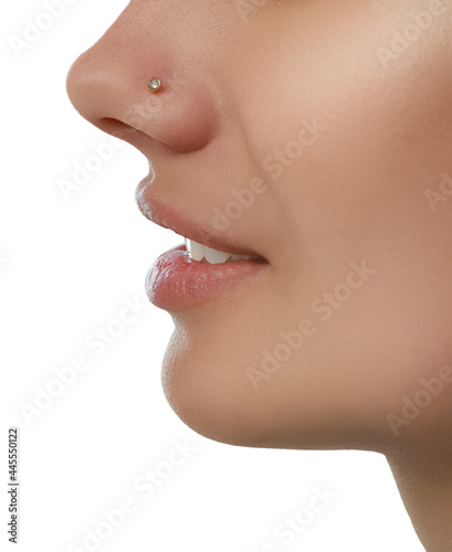 Young woman with nose piercing on white background, closeup