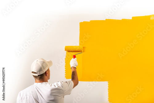 Male decorator painting a wall