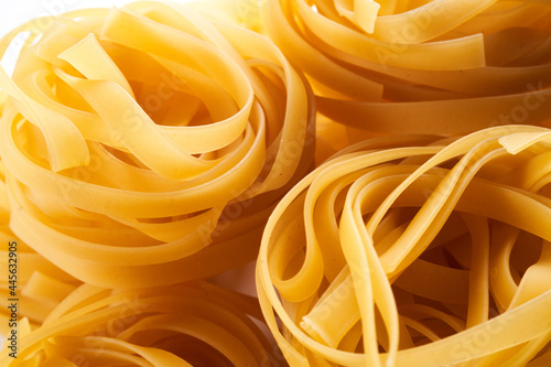 Italian egg pasta nest close-up. Fettuccine background