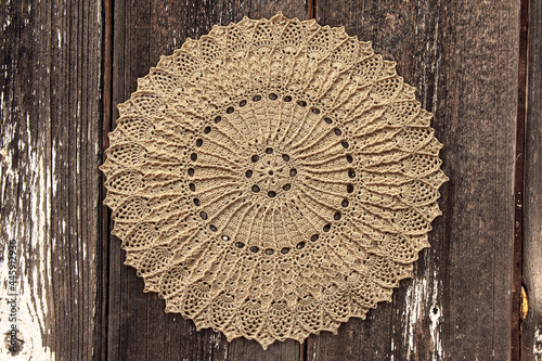 Beautiful closeup crochet doily on old wooden background