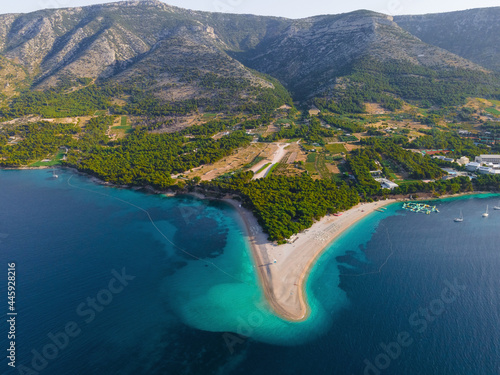 Aerial view of the Zlatni Rat sandy beach, sea and mountains on Brac island, Croatia made with drone