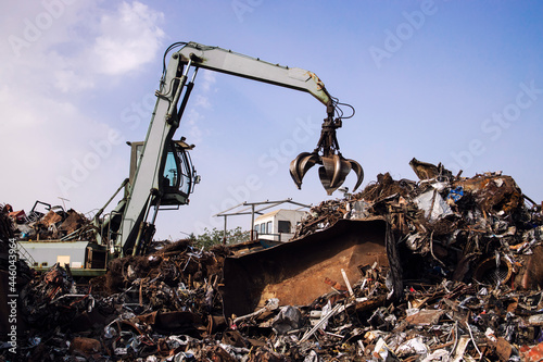 Industrial scrap metal recycling in junkyard.