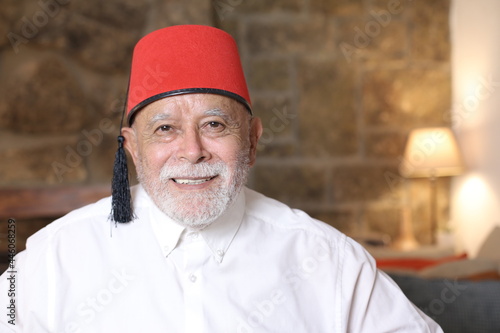 Mature middle Eastern man wearing classic fez hat