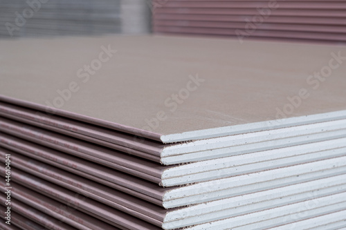 The stack of Plasterboard fire resistant gypsum board cardboard surface Panel Type DF for indoor concrete walls prepared for construction, selective focus