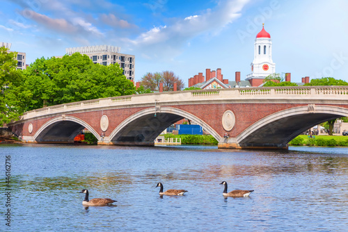 Vintage Bridge with clock tower over Charles River near Harvard University campus Boston