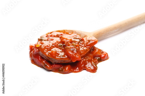 Pindjur vegetable relish made from red paprika, pepper and eggplant with wooden spoon isolated on white background