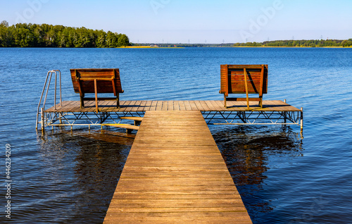Panoramic summer view of Jezioro Selmet Wielki lake landscape with recreation pier in Sedki village in Masuria region of Poland