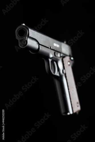 Colt 1911 pistol on the black background.