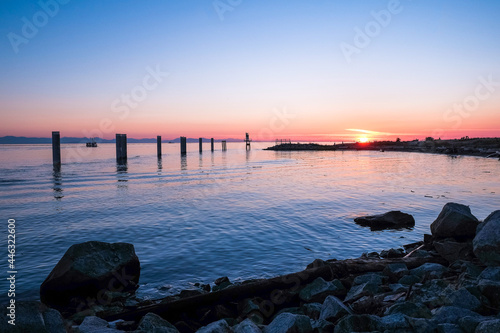 A sunset view of the Fraser River meets the Georgia Straight at Garry Point Park in Steveston, British Columbia.