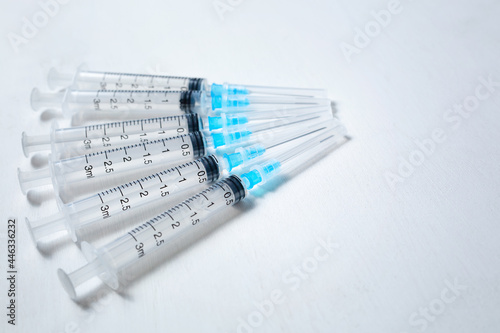 A hypodermic injection syringe. Syringes with blue needles. Medical Injectors. Copy space