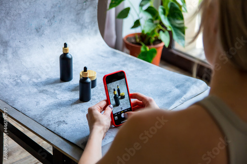 Woman make a photo of product for selling online in Internet from home