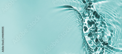 Trendy summer nature banner. Defocused aqua-mint liquid colored clear water surface texture with splashes bubbles with copy space. Water waves in sunlight background. 