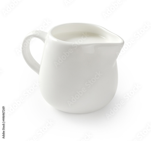 Ceramic milk jar isolated on white background. Milk pitcher for package design. Porcelain creamer pitcher with milk on white.