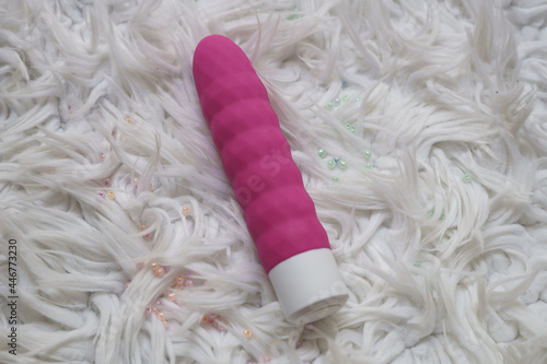 Pink dildo on a furry background