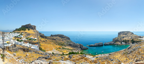 Lindos, with its ancient acropolis, ruins fortress and closed bays in sea coast, is the most view place of Rhodes island in Dodecanese, Greece. Vacation on Greece islands in Mediterranean sea.