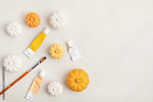 Hobby background with handmade gypsum pumpkins, paint brushes and art accessories