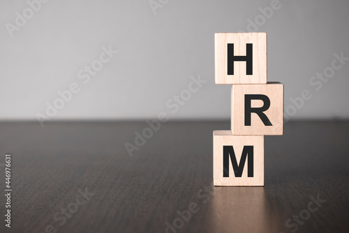 Businesswoman made word hrm with wood building blocks.