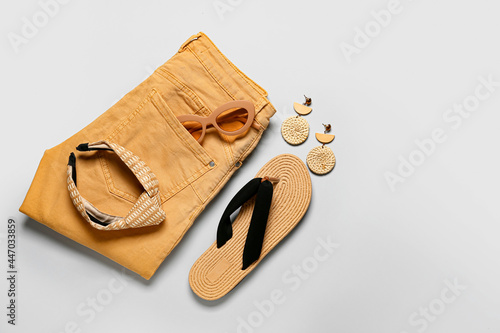 Set of female accessories with stylish sunglasses on grey background