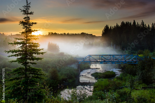 Fog and mist hover over Smith Crossing in Edmonton Alberta at sunset.