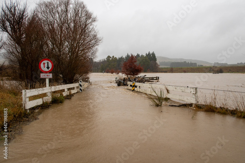 Heavy and continual rain causes the Hawkins River to flood and flow over nearby farms and roads in May, 2021, Canterbury, New Zealand