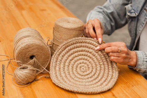 hands craftswoman knitting product from jute. Hobbies, needlework made from natural materials.