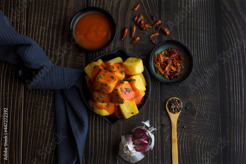 spicy Spanish patatas bravas with onion and garlic and pepper sauce