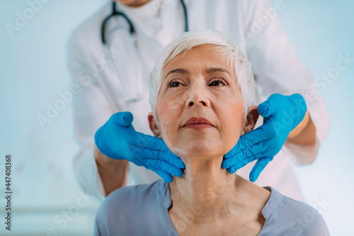 Thyroid Gland Control. Endocrinology Doctor Examining Senior Woman at Clinic.