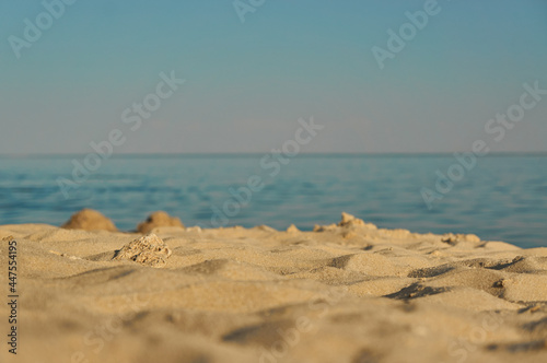 Empty beach on the sea in summer with golden yellow sand.