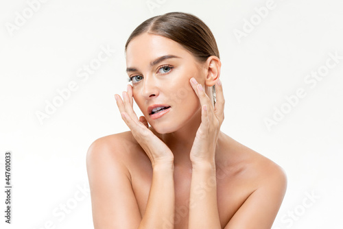 Smooth fresh glowing skin woman touching her face in white isolated studio background for beauty and skincare concepts