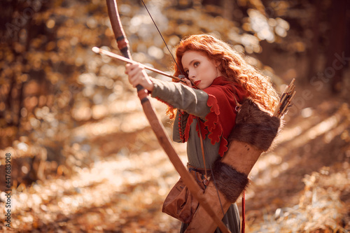 girl archer shooting in woods