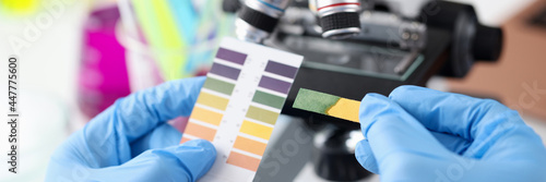 Scientist chemist holding ph test in his hands closeup