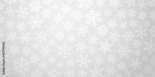 Christmas background with various complex big and small snowflakes in gray colors