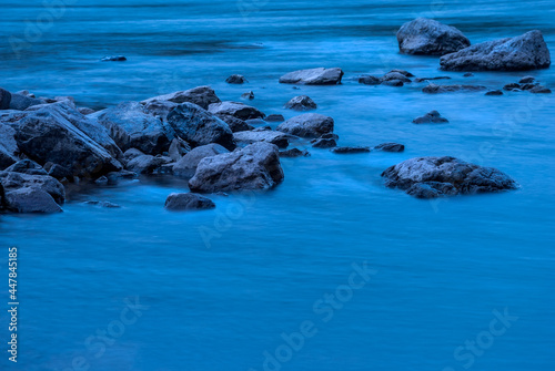 Mountain River. Stones and blue water on a long shutter speed.