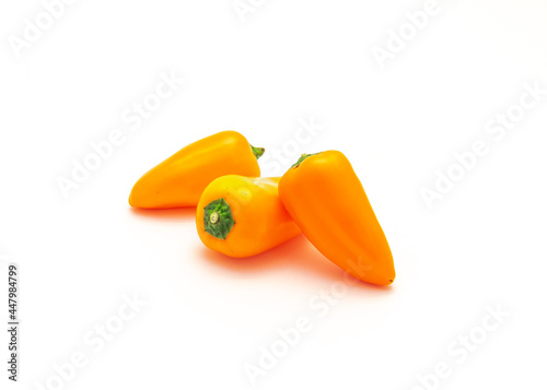 Three organic orange mini sweet peppers snack isolate on white