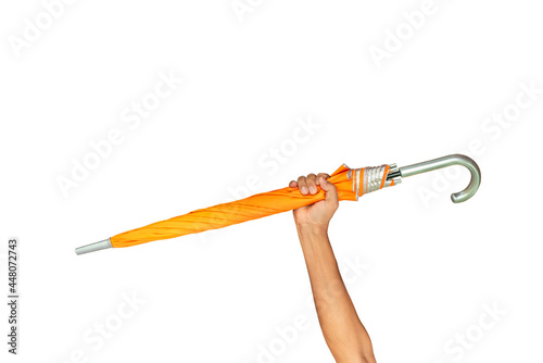 Hand holding an orange umbrella on a white background