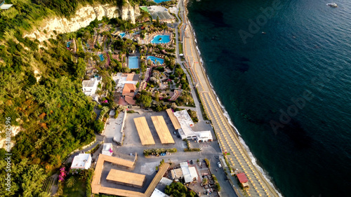 Overhead aerial view of Ischia Citara Beach at sunset with sand.