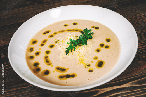 mushroom cream soup in bowl on wooden board