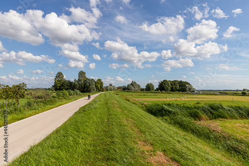 Clouds, a blue sky and a lot of wind above the rural polder landscape in the Netherlands.