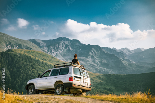 Person on top of 4x4 vehicle in the mountains of the Nationalpark Sharr, Brezovicë, Kosovo