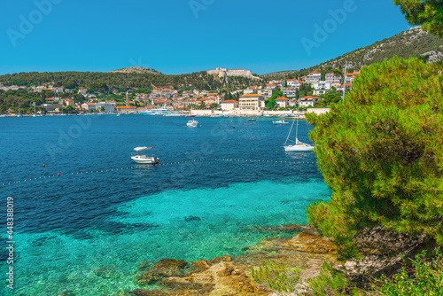 Turquoise water of Adriatic sea on Hvar island and Hvar old town in Dalmatia region, Croatia