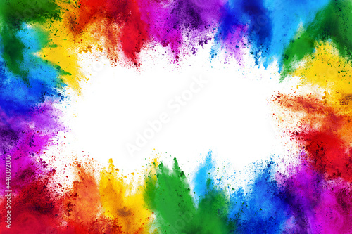 frame border with copy space of colorful rainbow holi paint color powder explosion isolated white background