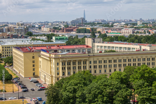 SAINT PETERSBURG, RUSSIA-JULY, 20, 2021: panoramic top view of the city with the roofs of houses, the road and trees against the background of green foliage of trees from the bell tower of the Smolny 