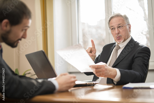 Senior businessman scolding an employee